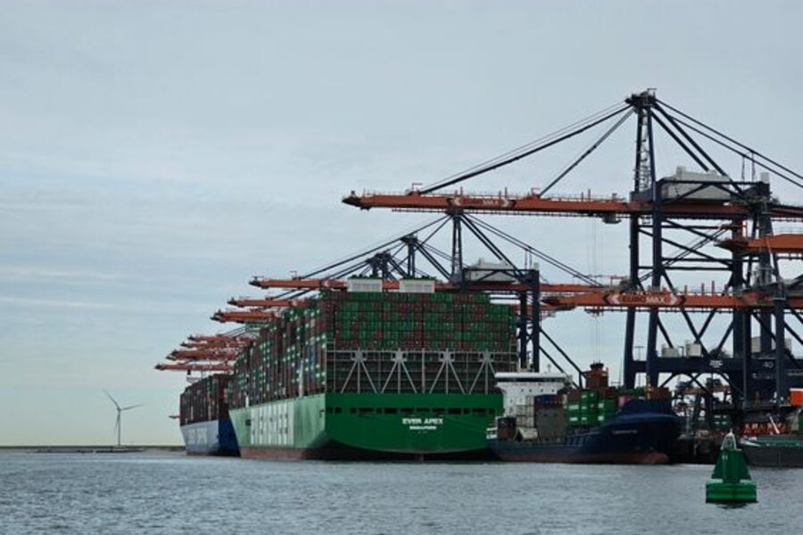 Container ship berthed beneath port cranes